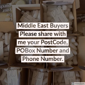 May include: Multiple open cardboard boxes filled with white foam packing peanuts and small white cards labeled Hand Made Ceramics Seray Yildiran. The text reads: Middle East Buyers Please share with me your PostCode, POBox Number and Phone Number.