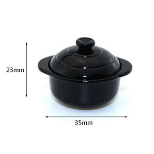 May include: A small black ceramic pot with a lid, measuring 3.5 inches in diameter and 2.3 inches in height.