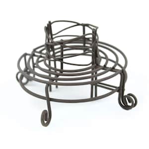 May include: A vintage wire cake stand with a circular base and three legs. The stand is made of dark metal and has a rustic look.