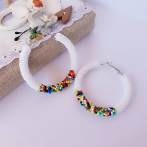 White and colorful statement beaded hoop earrings Large multicolor seed bead earrings Bright ethnic beadwork hoops Oversixed circle earrings