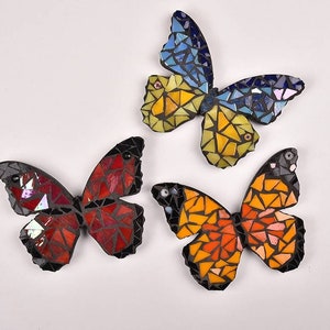 Mosaic fridge magnets, butterflies in glass.