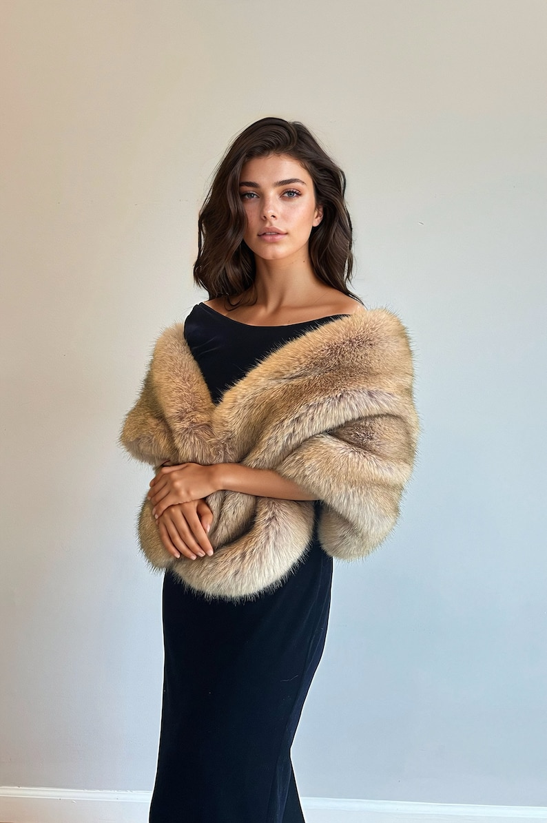 May include: A woman wearing a black dress with a long, light brown fur shawl.