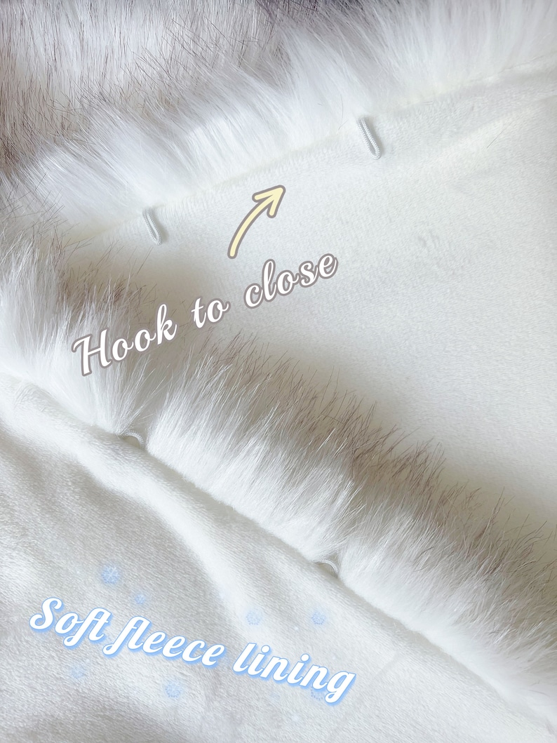 May include: White faux fur hooded scarf with a soft fleece lining. The scarf has two hooks on the inside to close the hood.