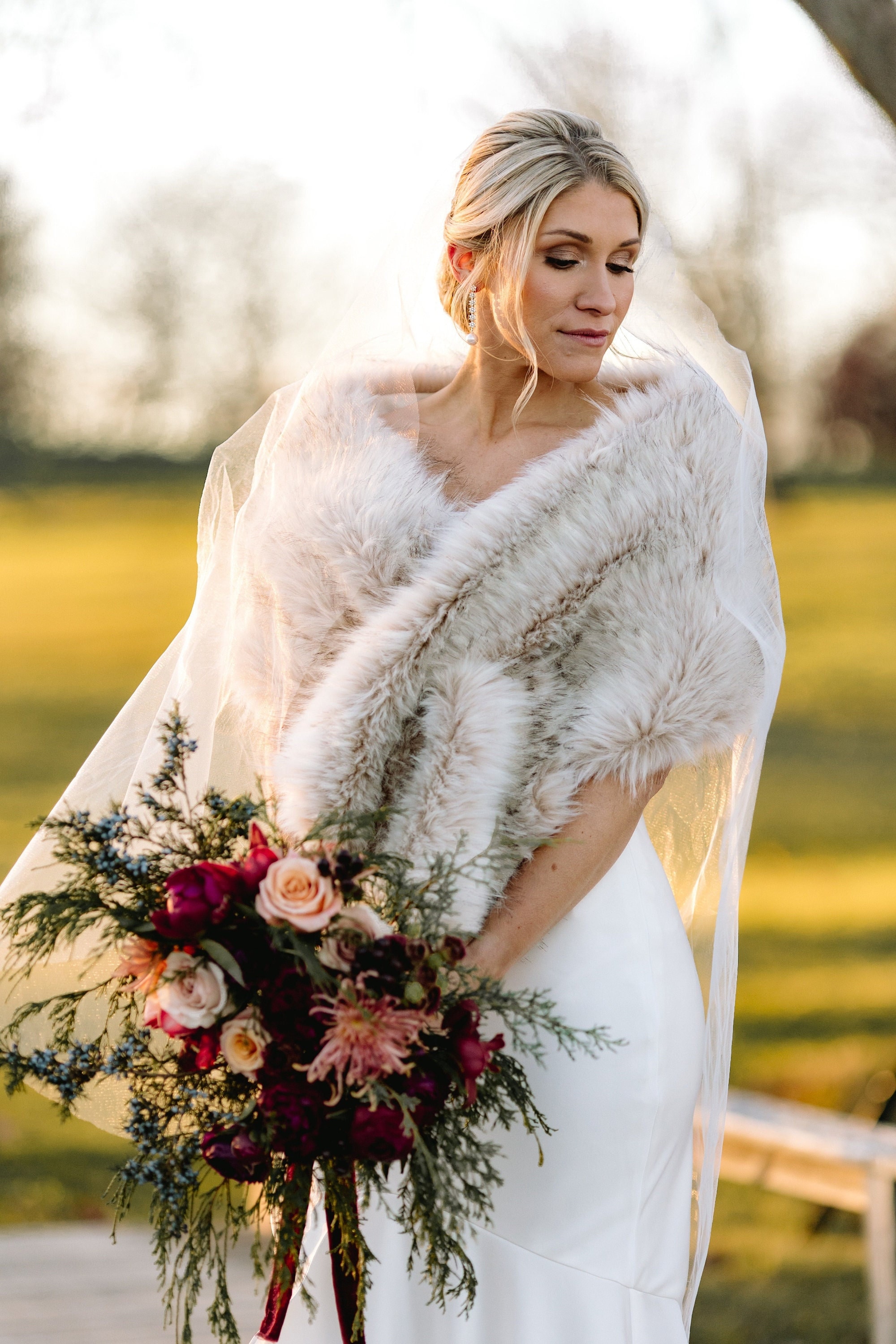 Bride wearing a shaggy fur shawl for Christmas wedding | Winter wedding  outfits, Outdoor winter wedding, Winter wedding dress