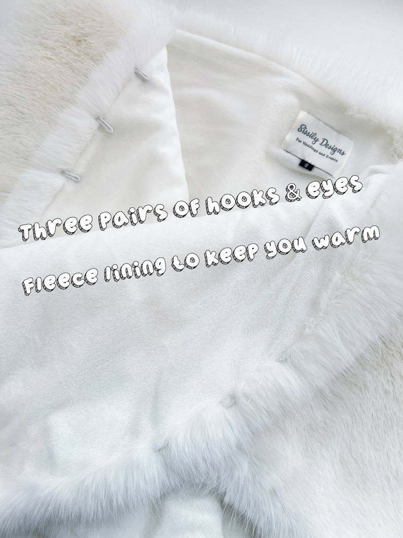 May include: White faux fur shawl with a fleece lining. The shawl has three pairs of hooks and eyes for closure. The label reads "Sisily Designs for Weddings and Events".