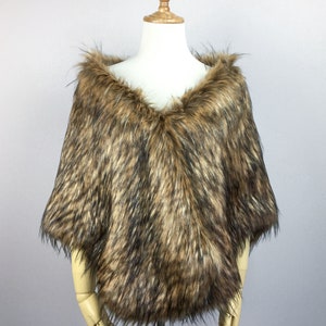 May include: A brown faux fur shawl with a V-neckline. The shawl is displayed on a wooden mannequin.