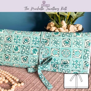 May include: A turquoise and white patterned jewellery roll with a matching tie closure. The roll features a repeating floral tile design. The text "The Michelle Jewellery Roll" is visible at the top of the image.