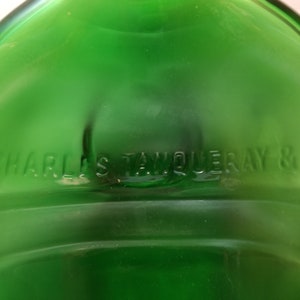 May include: A green glass bottle with the text "CHARLES TANQUERAY & CO" embossed on the bottom.