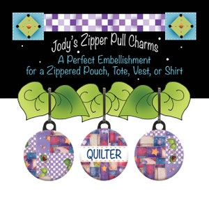 May include: Three purple, blue, and red patchwork fabric zipper pulls with a green leaf design. The middle zipper pull has the word "QUILTER" written on it.