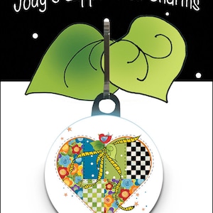 May include: A colorful patchwork heart-shaped zipper pull charm with a yellow ribbon and a small bird. The charm is attached to a black metal ring.