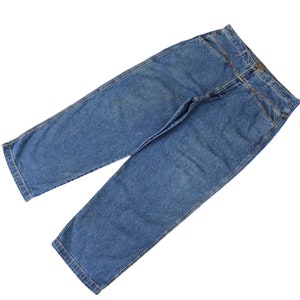 May include: A pair of blue denim jeans with a straight leg fit.