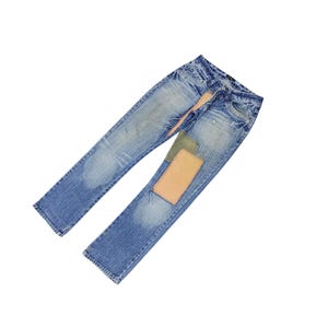 May include: Faded blue denim jeans with patches of tan and olive green fabric on the front. The jeans have a classic five-pocket design and a button and zipper closure. The denim has a worn, distressed look.