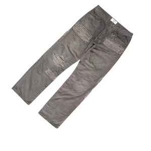 May include: Gray denim pants with distressed details, including rips and patches. The pants have a classic five-pocket design and a button and zipper closure. The fabric appears to be a medium weight, suitable for casual wear.