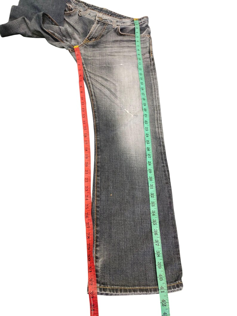 May include: A set of three ceramic mugs with a speckled, matte finish. Each mug features a different color: light blue, cream, and gray. The mugs have a simple, modern design and a comfortable handle.