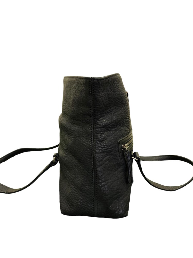 May include: A black leather tote bag with two shoulder straps. The bag has a zipped pocket on the front and a zipped closure at the top.