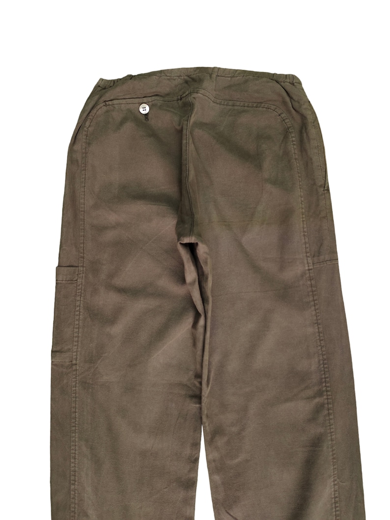 May include: A pair of brown cargo pants with a button on the back. The pants have a relaxed fit and are made of a durable fabric.