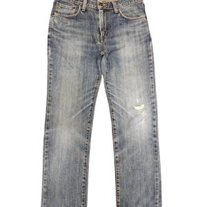 May include: Light blue denim jeans with a classic five-pocket design. The jeans have a faded wash and a distressed area on the right leg. The jeans are straight-legged and have a button and zipper closure.