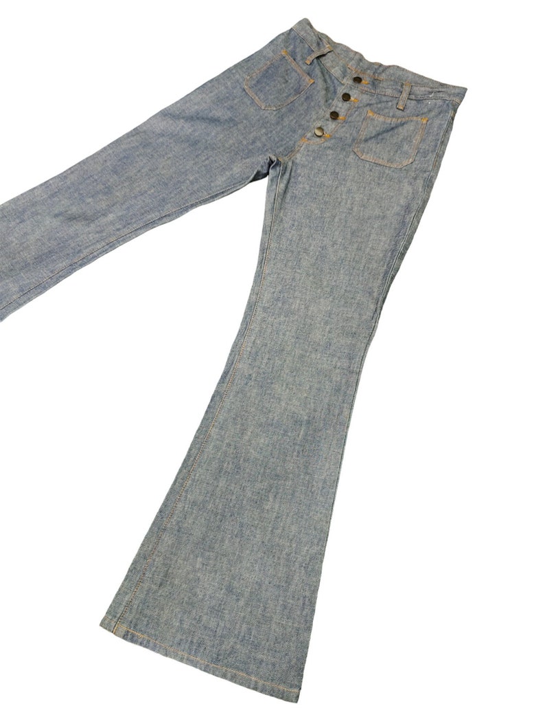 May include: A pair of light blue denim bell bottom pants with a button fly and multiple pockets.
