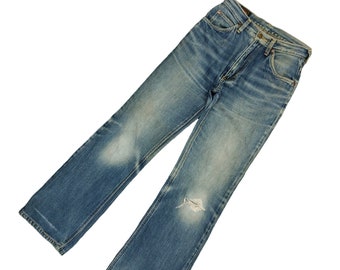 May include: A pair of blue denim jeans with a distressed look. The jeans have a straight leg and a light wash.