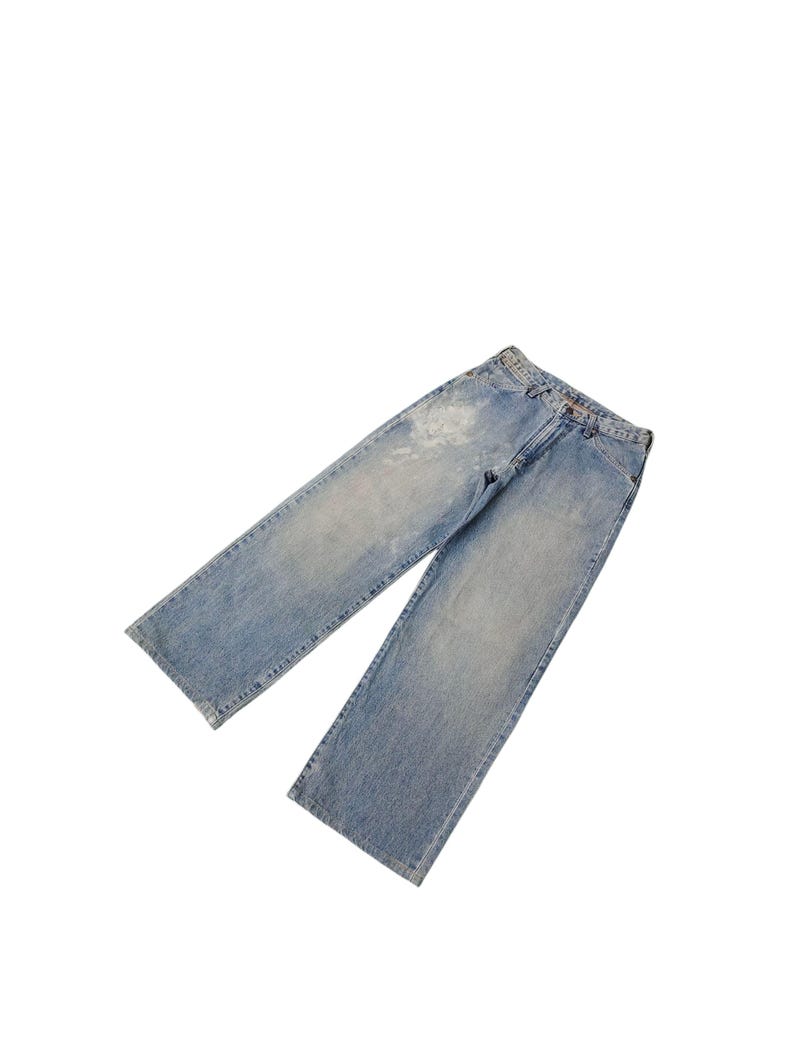 May include: Light blue denim jeans with a faded wash and a straight leg design. The jeans have a classic five-pocket style and a button and zipper closure. The denim has some distressed areas.