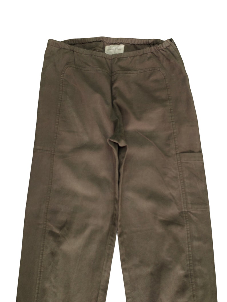 May include: A pair of brown cargo pants with a drawstring waist and multiple pockets.