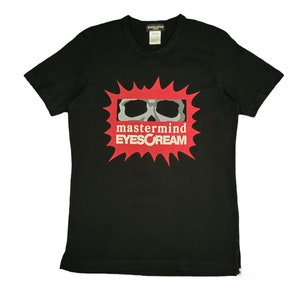 May include: Black t-shirt with a red and white graphic of a skull with the text "mastermind EYESCREAM"