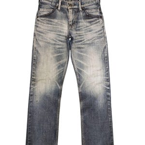 May include: Faded blue denim jeans with a straight leg cut. The jeans have a worn appearance with lighter areas on the thighs and knees. A red tag is visible on the inside waistband. The jeans have classic five-pocket styling.