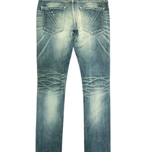 May include: A white ceramic mug with a black handle and the text "But First, Coffee" in a black, bold font. The mug is on a white surface. The mug is 4 inches tall.