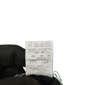 May include: Close-up of a clothing tag with Japanese text and care symbols. The tag lists fabric composition as 99% cotton and 1% polyurethane. Includes washing instructions and the manufacturer's information.