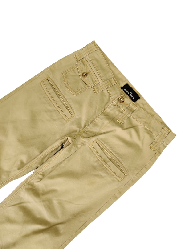 Puede incluir: Un pantal&oacute;n cargo color caqui con m&uacute;ltiples bolsillos. El pantal&oacute;n tiene una etiqueta negra con el texto "JACK & JONES" en el lado derecho.