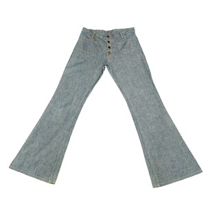 May include: A pair of light blue denim bell bottom pants with a button fly and two front pockets.