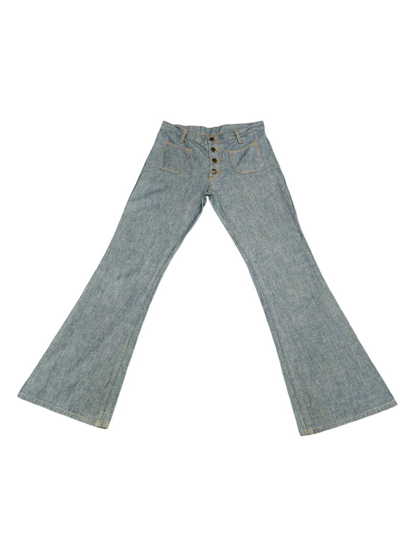 May include: A pair of light blue denim bell bottom pants with a button fly and two front pockets.