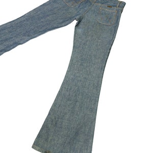 May include: A pair of light blue denim bell bottom jeans. The jeans have a classic five-pocket style with a slightly faded wash.