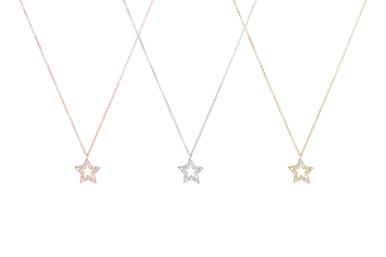 All three color options of the solid gold necklace with a diamond star charm and a thin cable chain. Rose, white and yellow gold, every option displayed right next to each other on a white background.