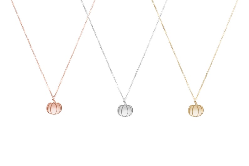 All three color options of the solid gold pendant necklace with a pumpkin charm with engraved details. Rose, white and yellow gold, every option displayed right next to each other on a white background.