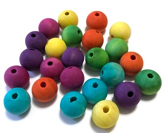May include: A collection of colorful wooden beads in various shades, including purple, orange, green, yellow, and blue. Each bead is round with a hole drilled through the center, ideal for crafting and jewelry making.