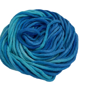 May include: A ball of blue yarn in varying shades of turquoise and blue. The yarn is tightly wound, creating a dense, textured appearance. The color transitions smoothly from light to dark, suggesting a gradient effect. Ideal for knitting and crochet projects.