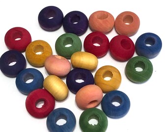 May include: A collection of round, wooden beads in a variety of colors including red, blue, green, yellow, purple, and peach. Each bead features a central hole and a smooth, matte finish, scattered across a plain white background.
