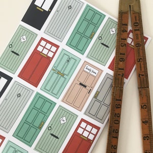 May include: A white sheet of paper with colorful illustrations of doors. Each door has a different number, including "One" and "Twenty Seven".