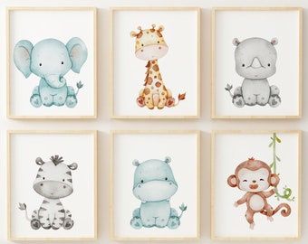 May include: Set of six watercolor animal illustrations in a light wood frame. The animals include a blue elephant, a giraffe with brown spots, a gray rhinoceros, a zebra with black stripes, a blue hippopotamus, and a brown monkey hanging from a vine.