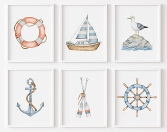 May include: Set of six nautical themed watercolour prints in white frames. The prints feature a life preserver, sailboat, seagull, anchor, oars, and a ship's wheel.