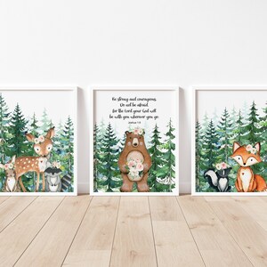 May include: Three watercolor illustrations of woodland animals with floral crowns in a forest setting. The center illustration features a bear holding flowers and the text "Be strong and courageous. Do not be afraid, for the Lord your God will be with you wherever you go."