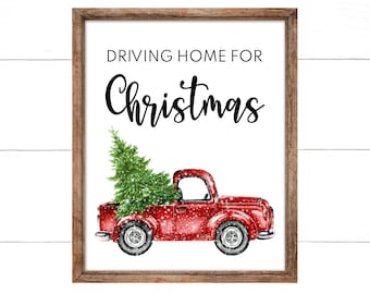 May include: A red vintage pickup truck with a Christmas tree in the bed, driving home for Christmas. The truck is on a white background with a wood grain texture.