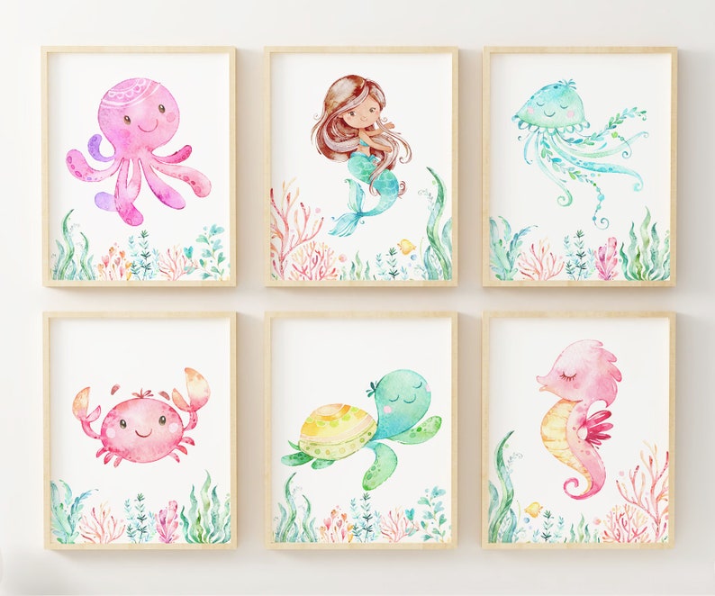 May include: Set of six watercolour illustrations featuring various sea creatures, including an octopus, mermaid, jellyfish, crab, turtle, and seahorse. Each illustration is framed in a light wood frame and features a white background with watercolour details of coral and seaweed.