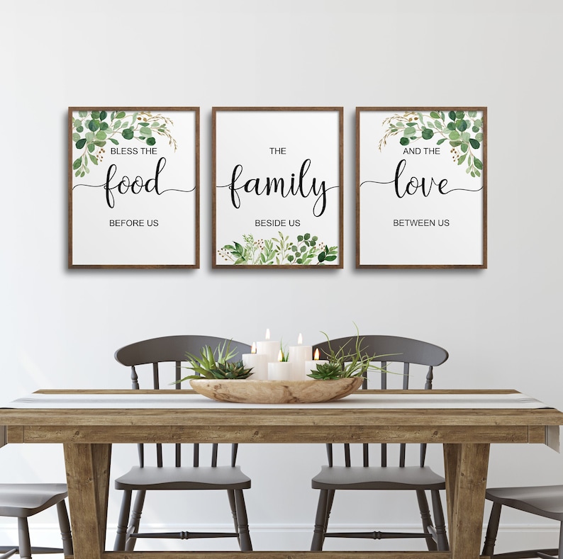 May include: Three framed prints with a white background and green foliage designs. The text on the prints reads "Bless the food before us", "The family beside us", and "And the love between us".