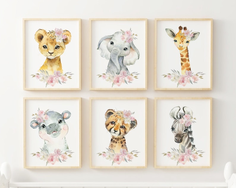 May include: Set of six watercolour animal prints featuring a lion, elephant, giraffe, hippopotamus, cheetah, and zebra. Each animal is depicted with a floral crown and surrounded by pink flowers.