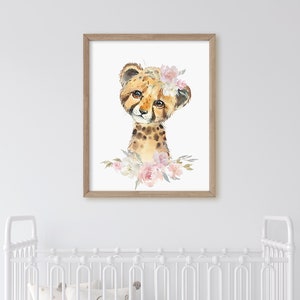 May include: A watercolour painting of a cheetah cub wearing a pink flower crown. The cheetah is looking at the viewer with large, brown eyes. The background is white.