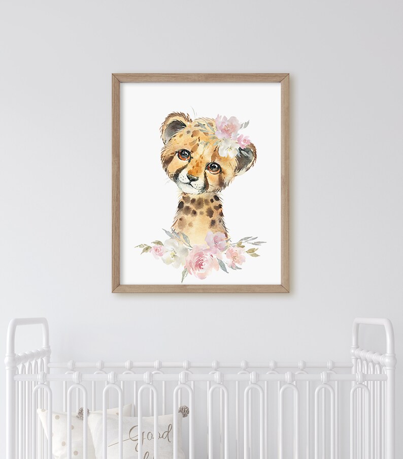 May include: A watercolour painting of a cheetah cub wearing a pink flower crown. The cheetah is looking at the viewer with large, brown eyes. The background is white.