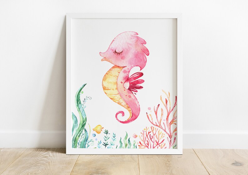 May include: A watercolour illustration of a pink and yellow seahorse with closed eyes, surrounded by green and red seaweed.