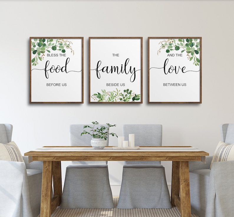 May include: Three framed prints with green foliage and white backgrounds. The prints feature the text "Bless the food before us", "The family beside us", and "And the love between us".